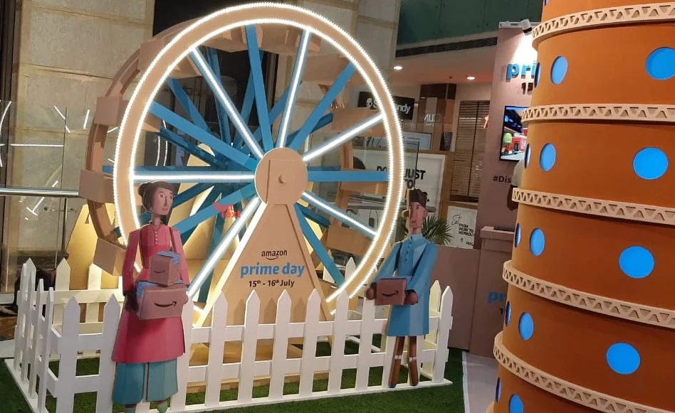 Amazon Prime Day cardboard ferris wheel installation with parcel-carrying figures