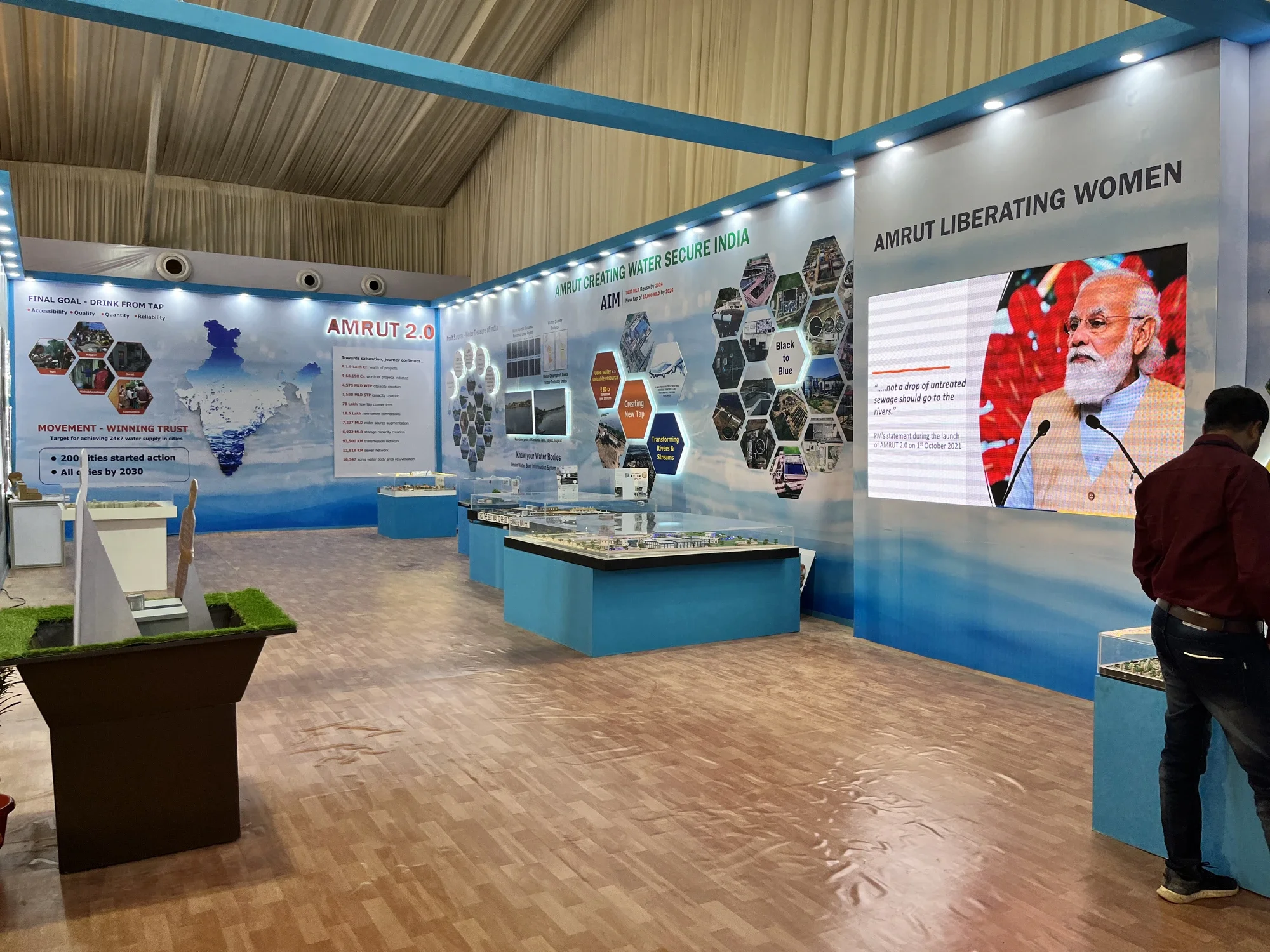 Pavilion walkthrough with the AMRUT Liberating Women media wall and city models