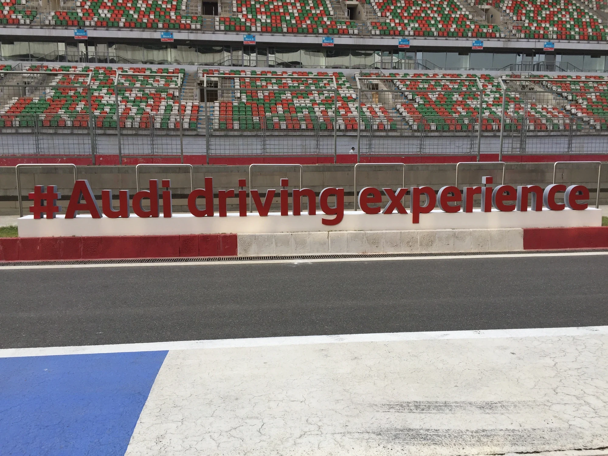 #AudiDrivingExperience red letter installation along the circuit grandstand