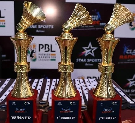 Golden shuttlecock trophies for the Winner and Runners Up at Clash of the Baddies
