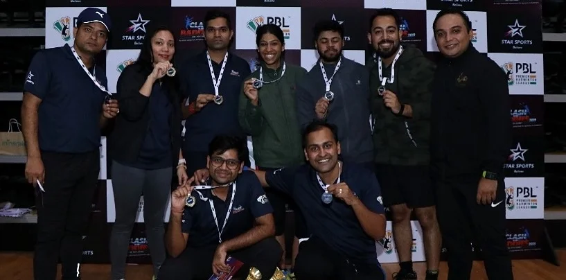 Medal winners posing against the Star Sports, PBL and Clash of the Baddies backdrop