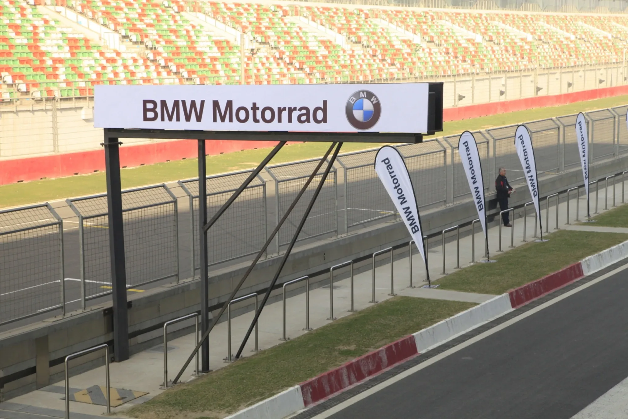 BMW Motorrad branded gantry and feather flags along the pit lane at Buddh International Circuit