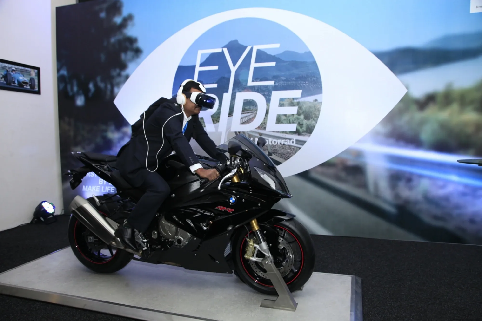 Guest experiencing the EYE RIDE virtual reality simulator on a BMW S 1000 RR