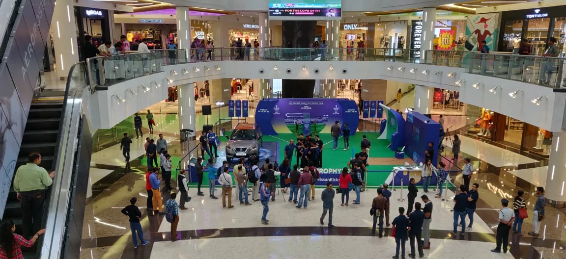Aerial view of crowds gathered around the Trophy Tour activation in the mall atrium
