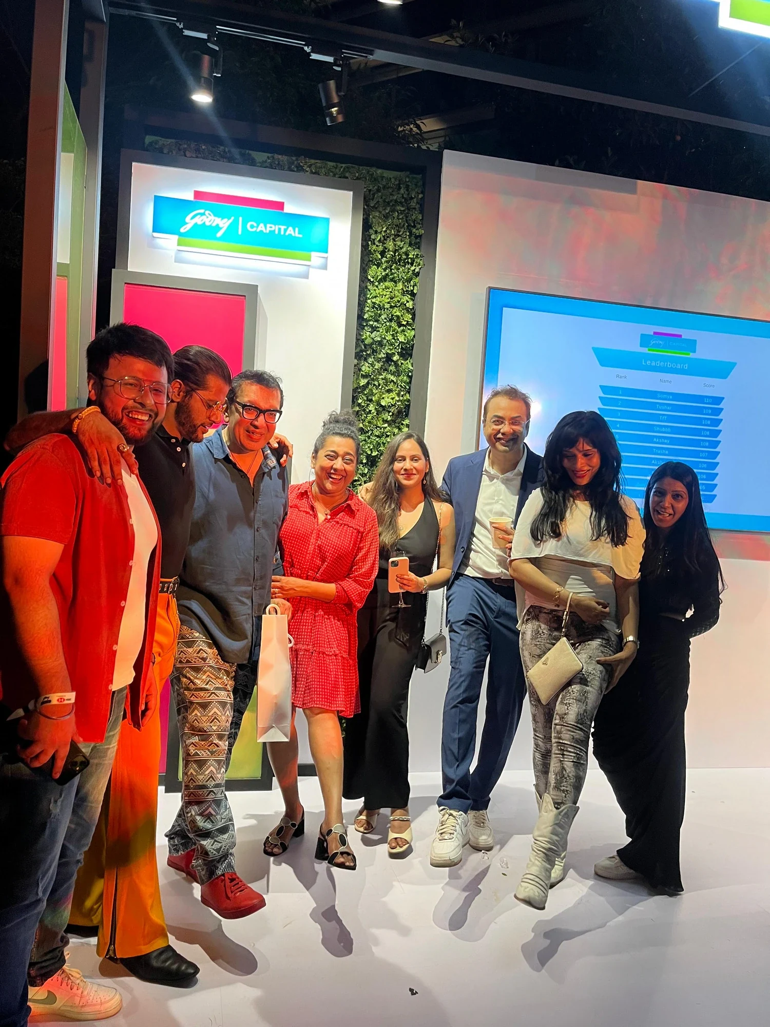 Guests and the team at the Godrej Capital booth with the live game leaderboard
