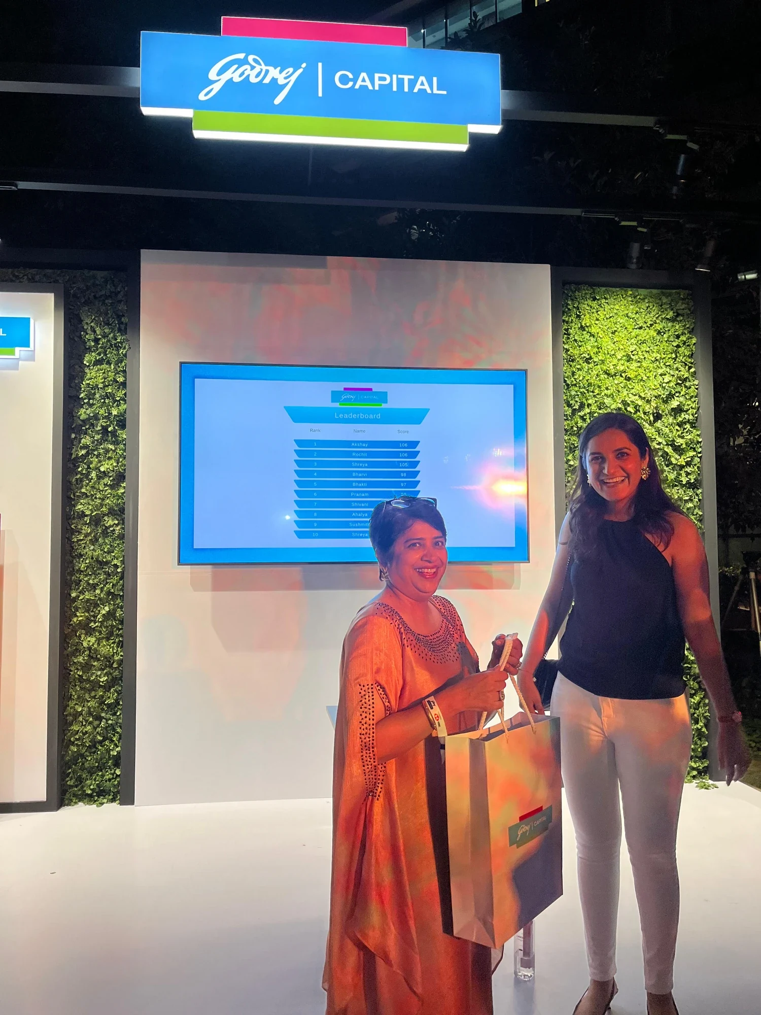 Leaderboard winner collecting her Godrej Capital gift bag at the booth