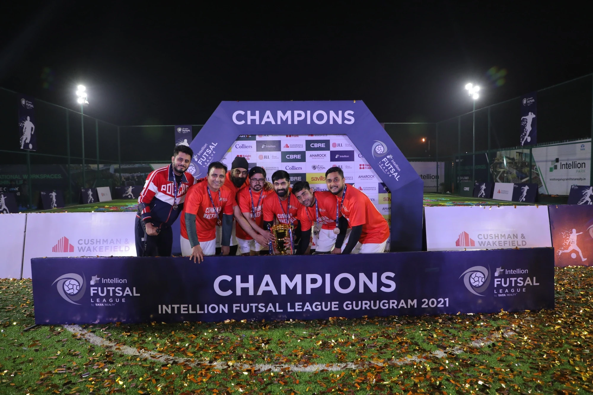 Season 1 champions celebrating with the trophy on the CHAMPIONS podium