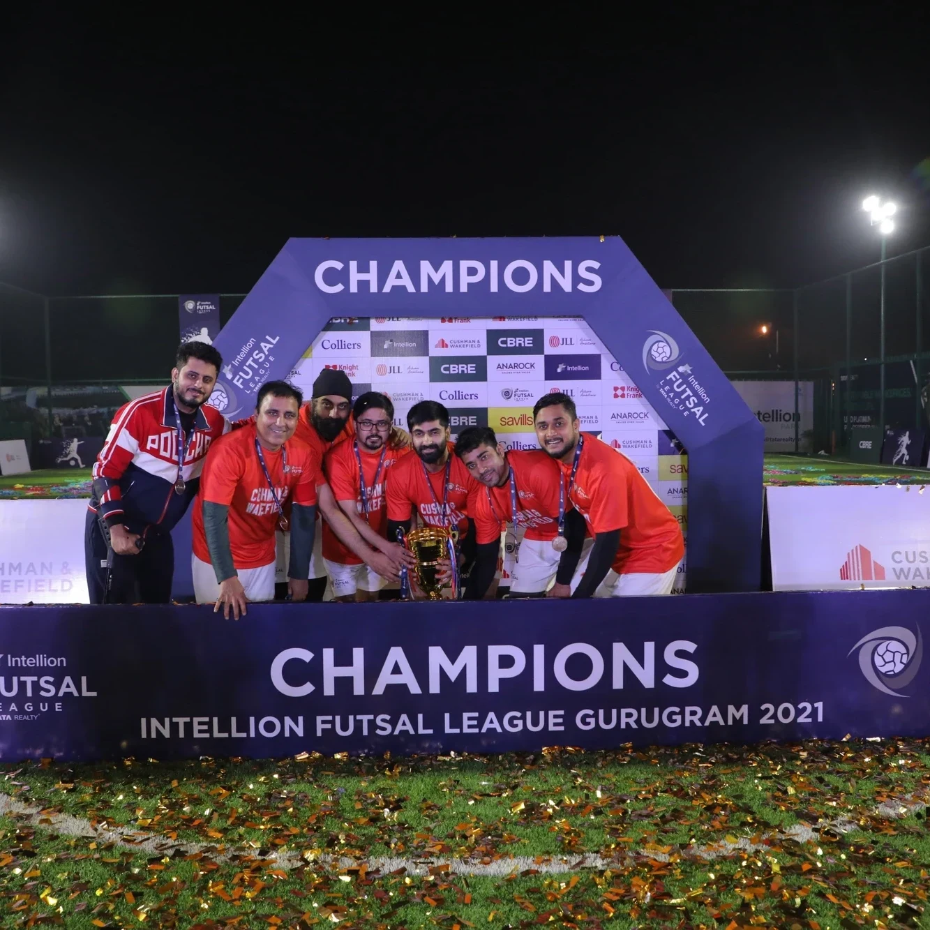 Intellion Futsal League Season 1 champions on the podium with the trophy