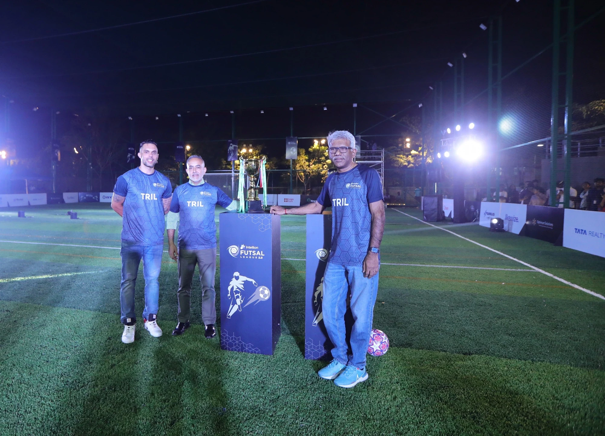 TRIL leadership with the Intellion Futsal League 2.0 trophy on the branded podium