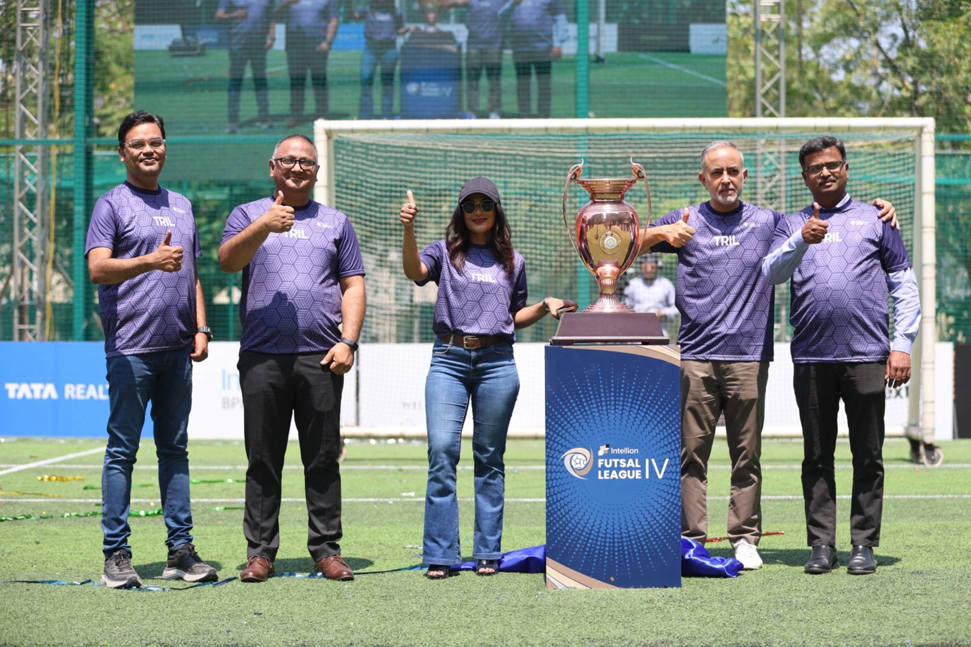 TRIL leadership unveiling the Intellion Futsal League IV trophy on its branded podium