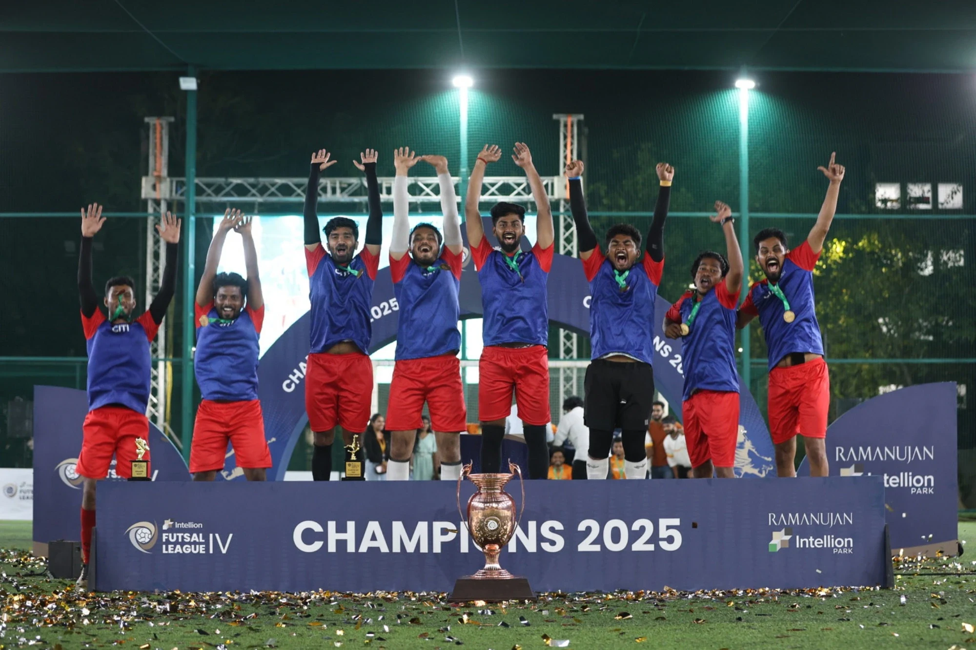 Champions 2025 — winning team jumping in celebration on the podium