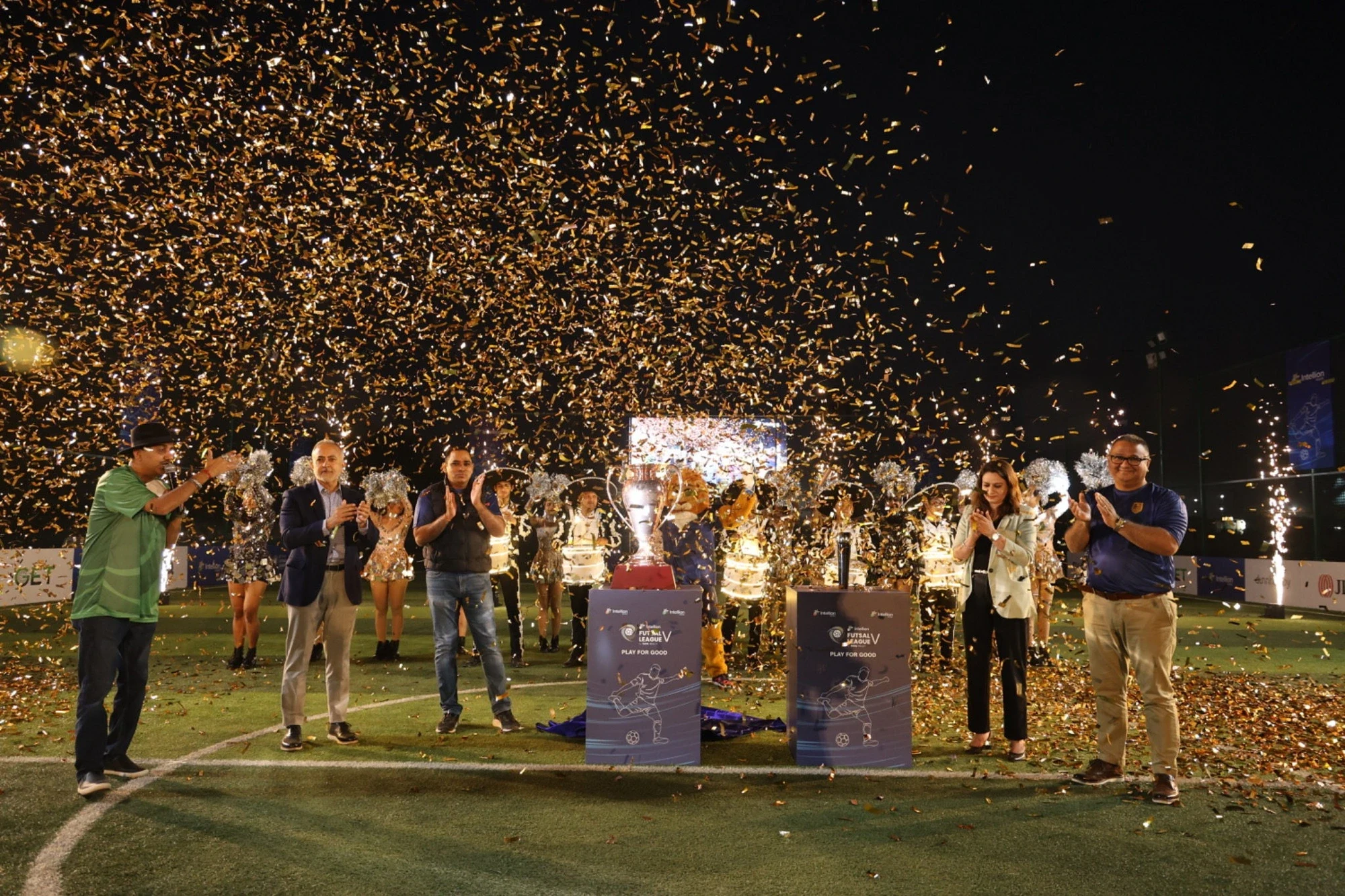 TRIL leadership unveiling the Intellion Futsal League V trophy under a shower of golden confetti