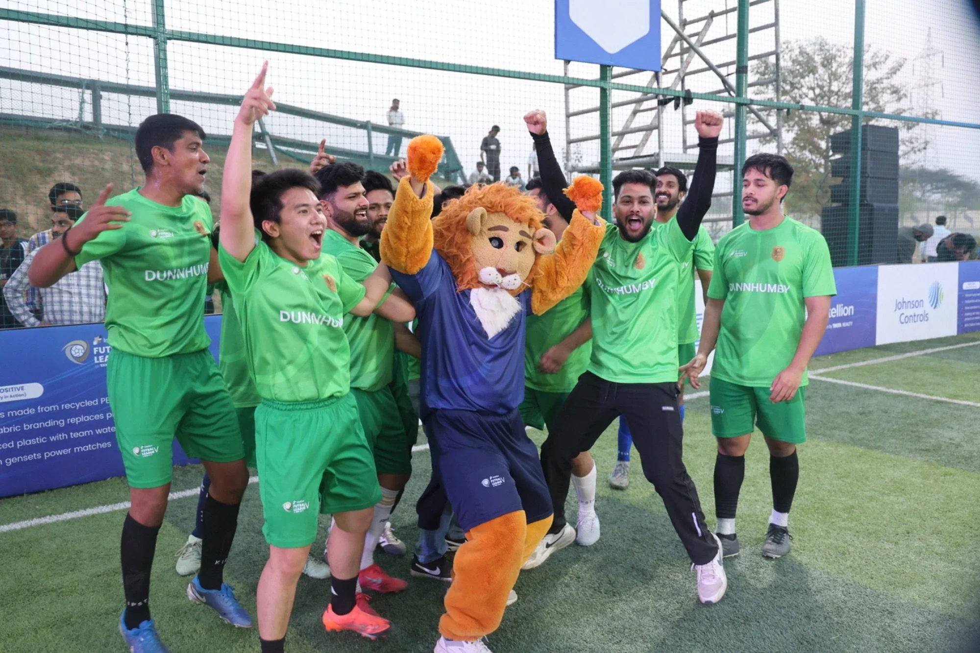 Dunnhumby team celebrating with Leo the mascot at Intellion Futsal League V