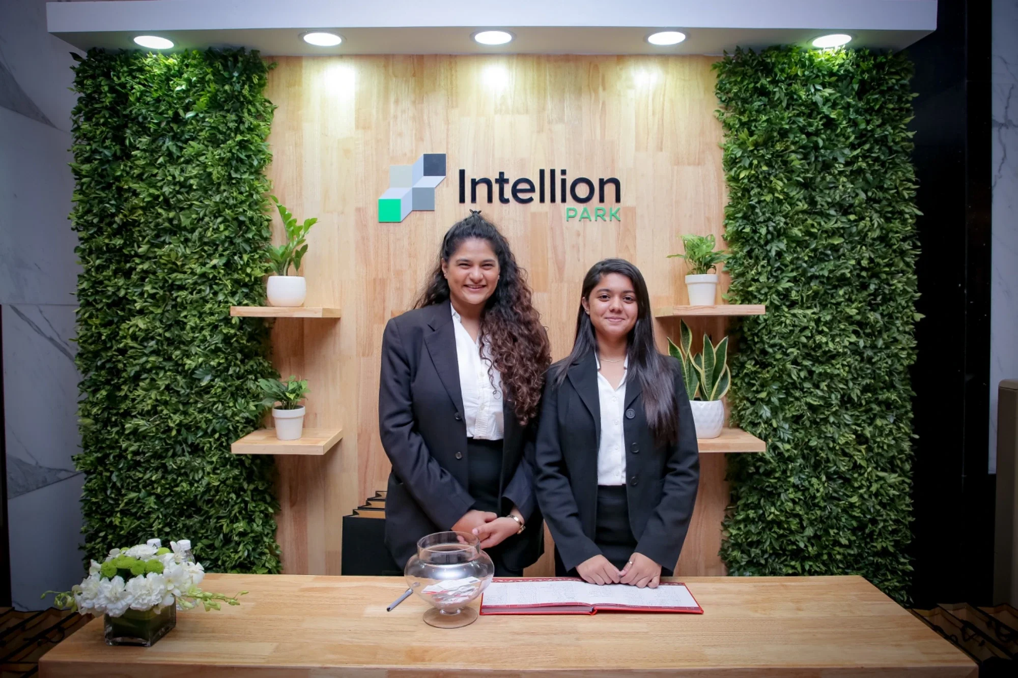 Welcome desk at the Intellion Park themed entrance with vertical garden walls