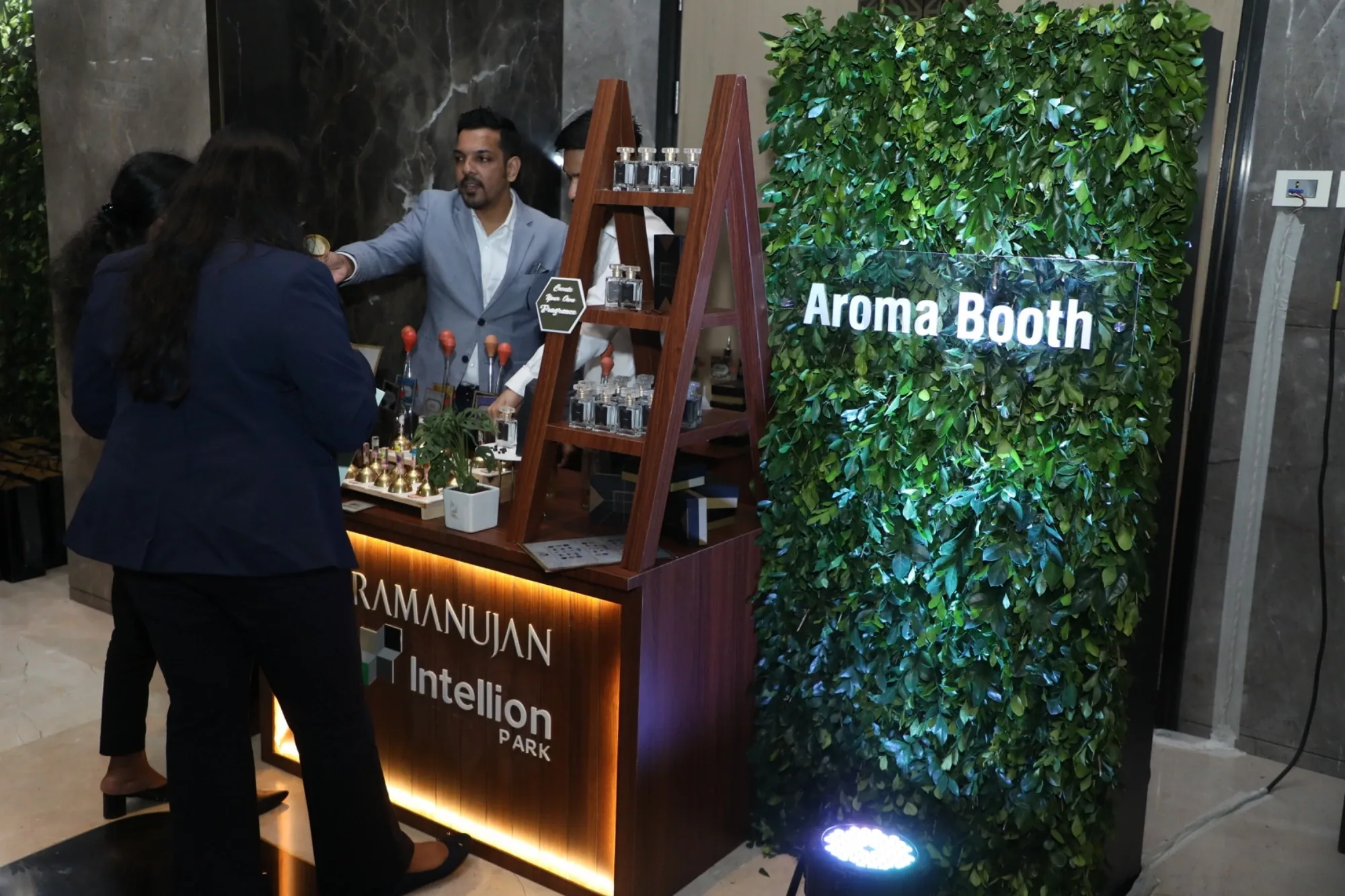 Aroma Booth with personalised fragrance blending against a vertical garden backdrop