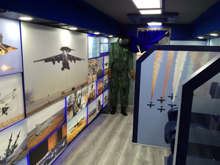 History zone inside the vehicle — backlit IAF photo wall and flight suit display
