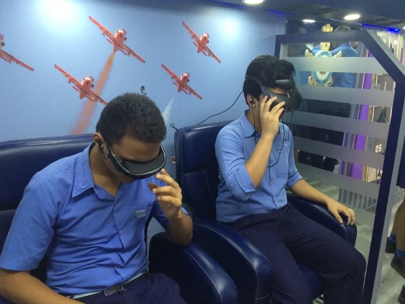 Students experiencing the flight simulator VR headsets inside the IPEV