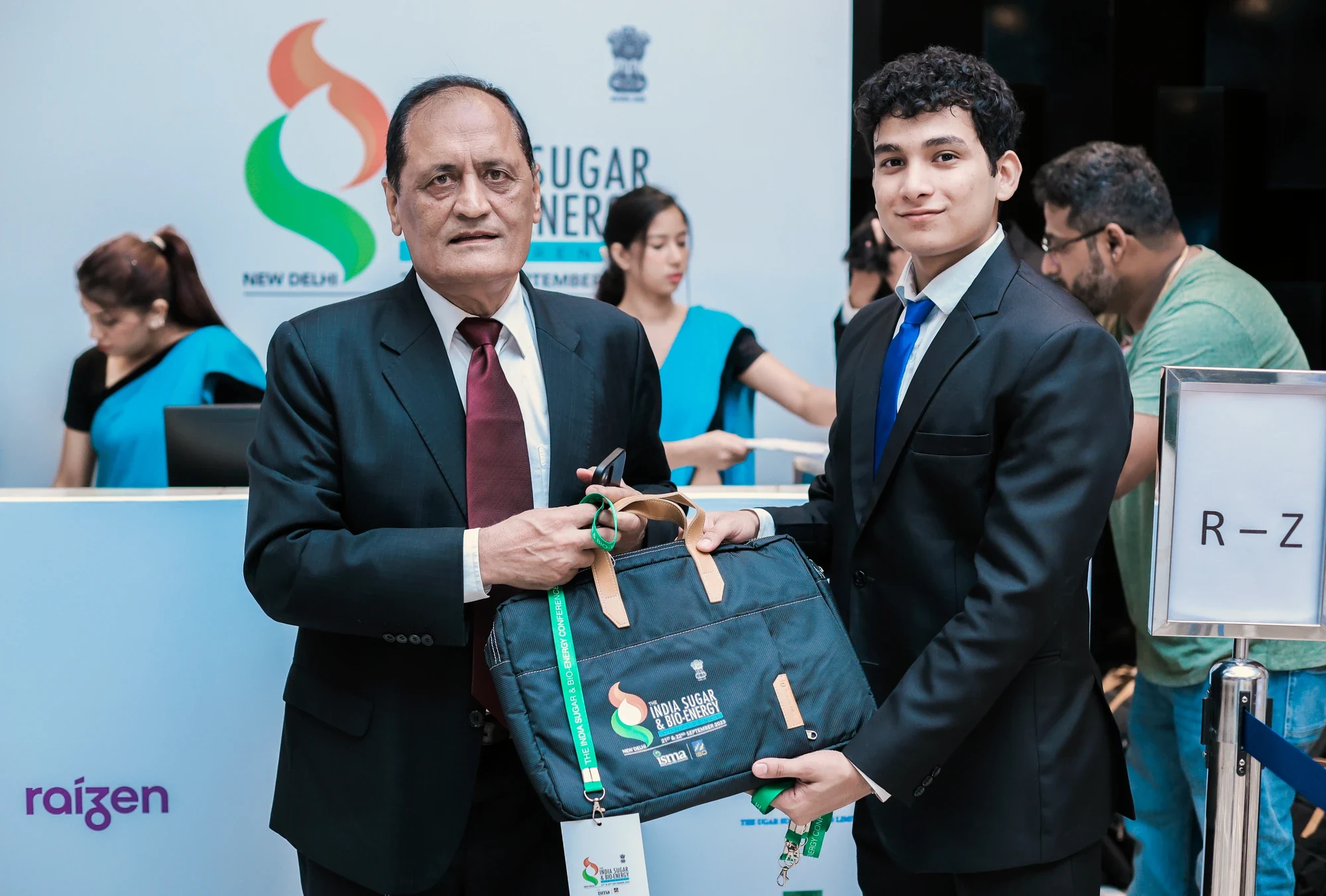 Delegate receiving the branded conference kit bag at registration