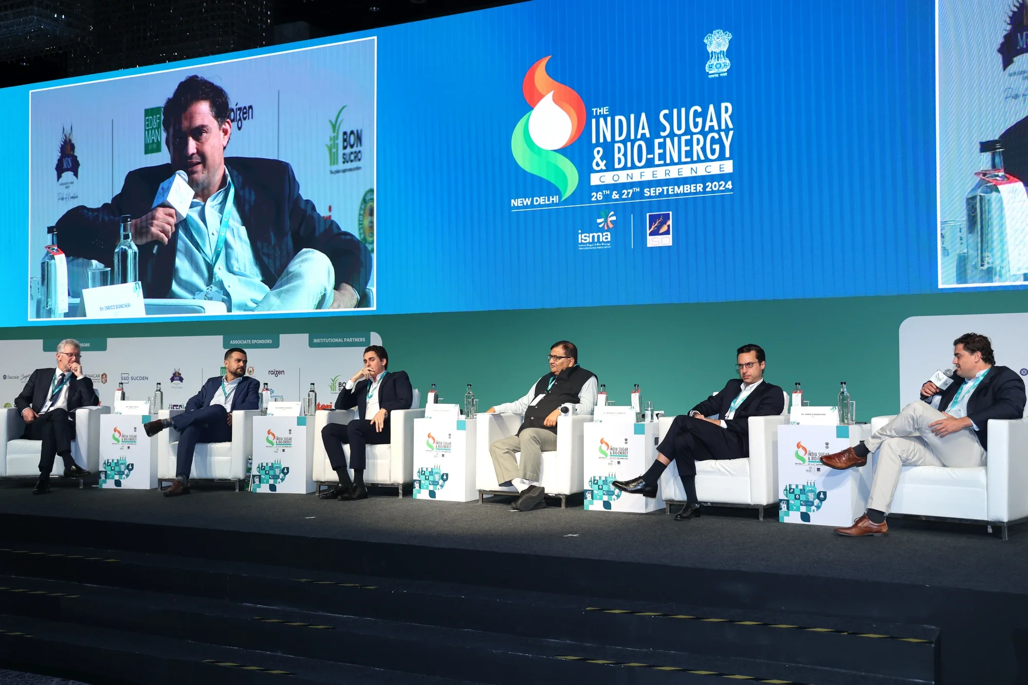 Panel discussion at the India Sugar & Bio-Energy Conference 2024 with the speaker on the main LED screen