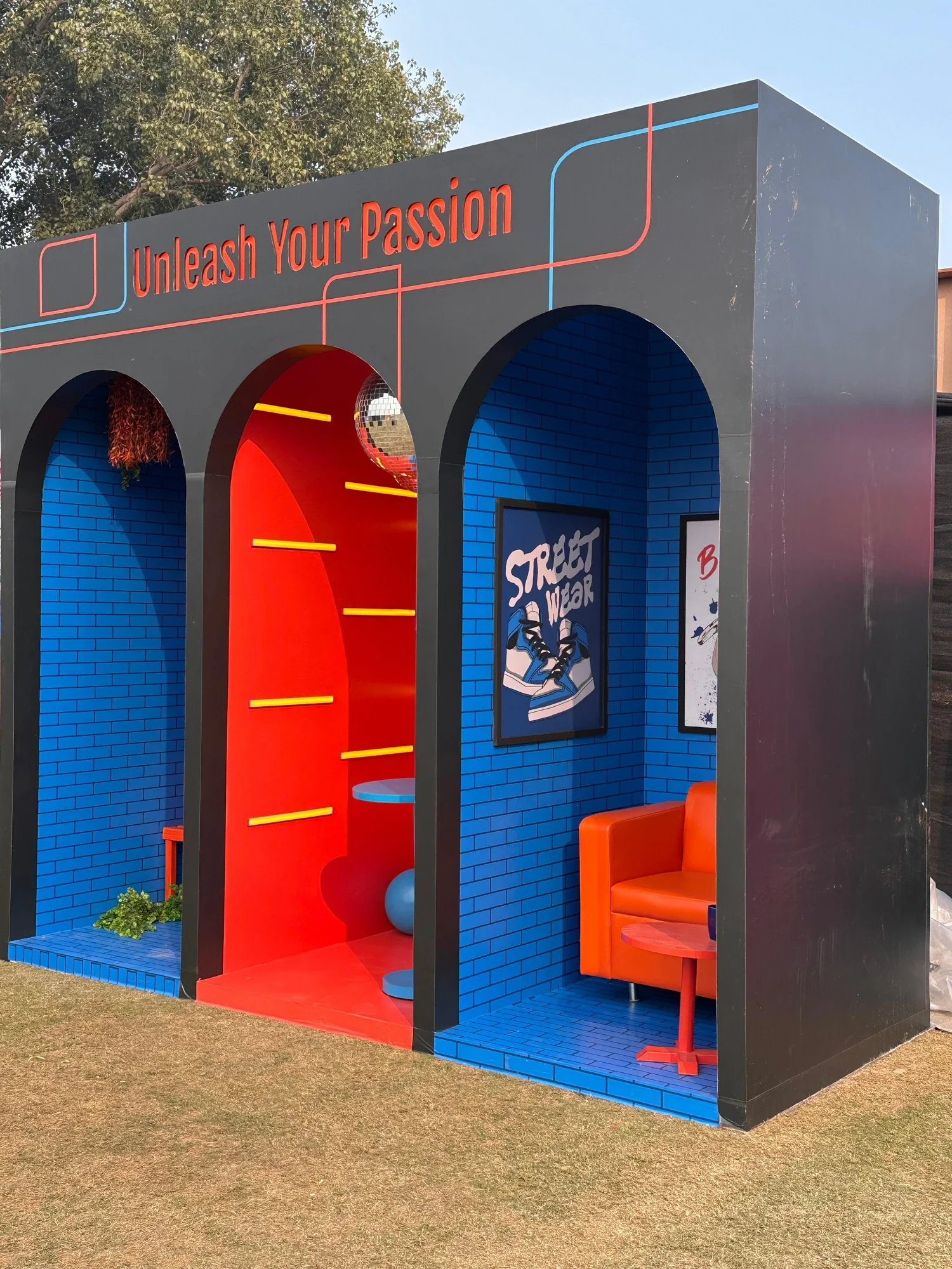 Unleash Your Passion zone by day — three arched rooms in red and blue with street-wear posters