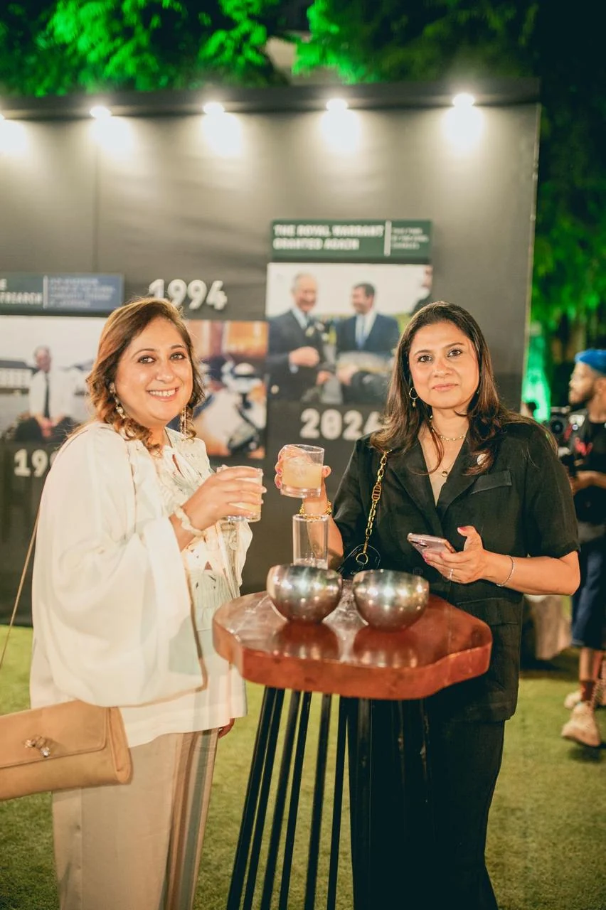 Guests toasting beside the Laphroaig heritage timeline wall