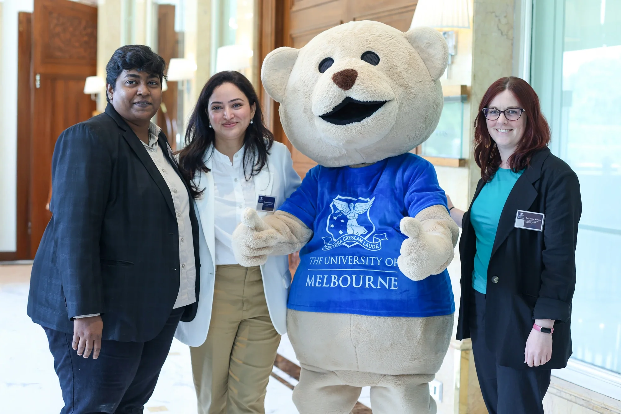 The University of Melbourne mascot bear with the roadshow team