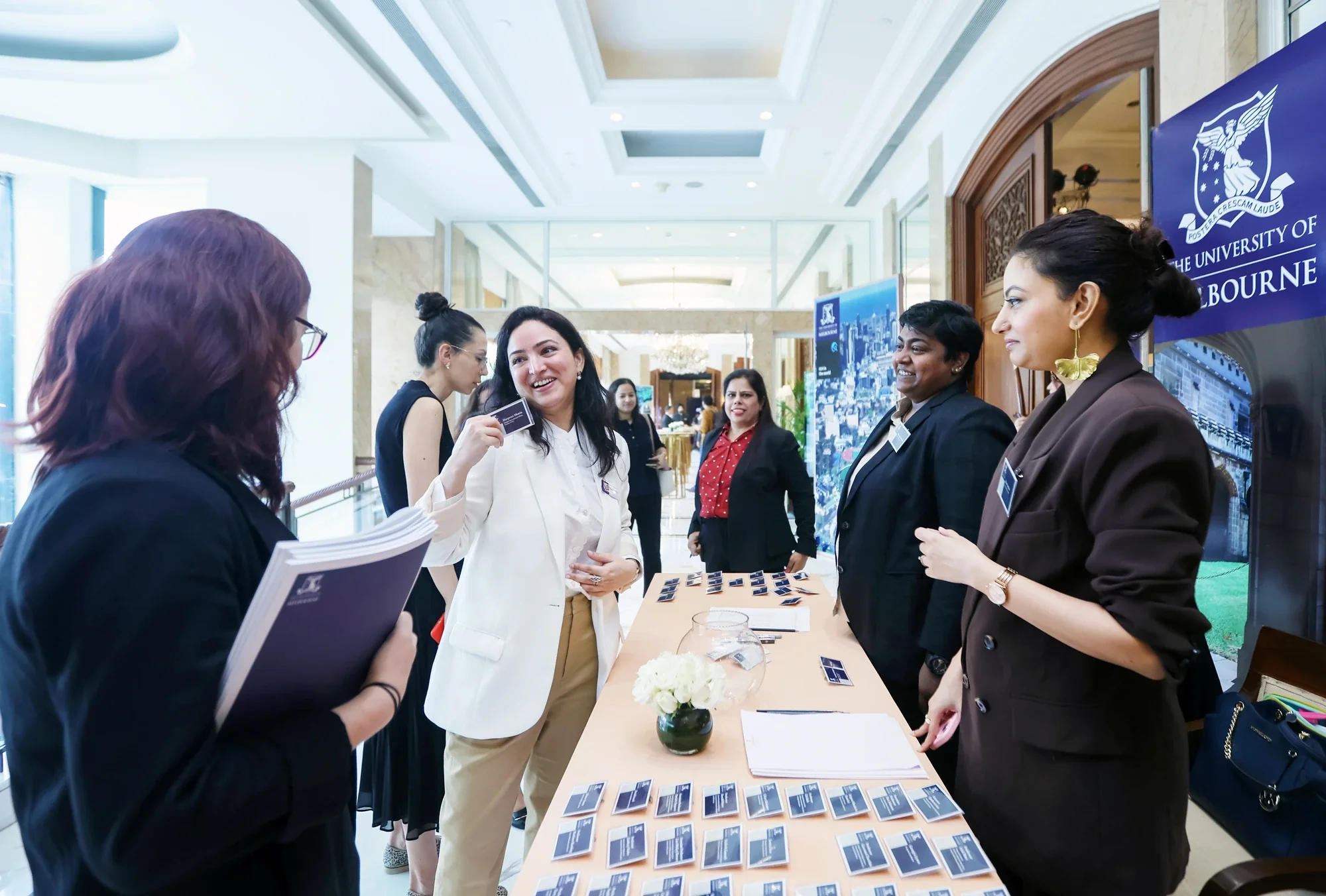 Guests registering at the University of Melbourne roadshow welcome desk