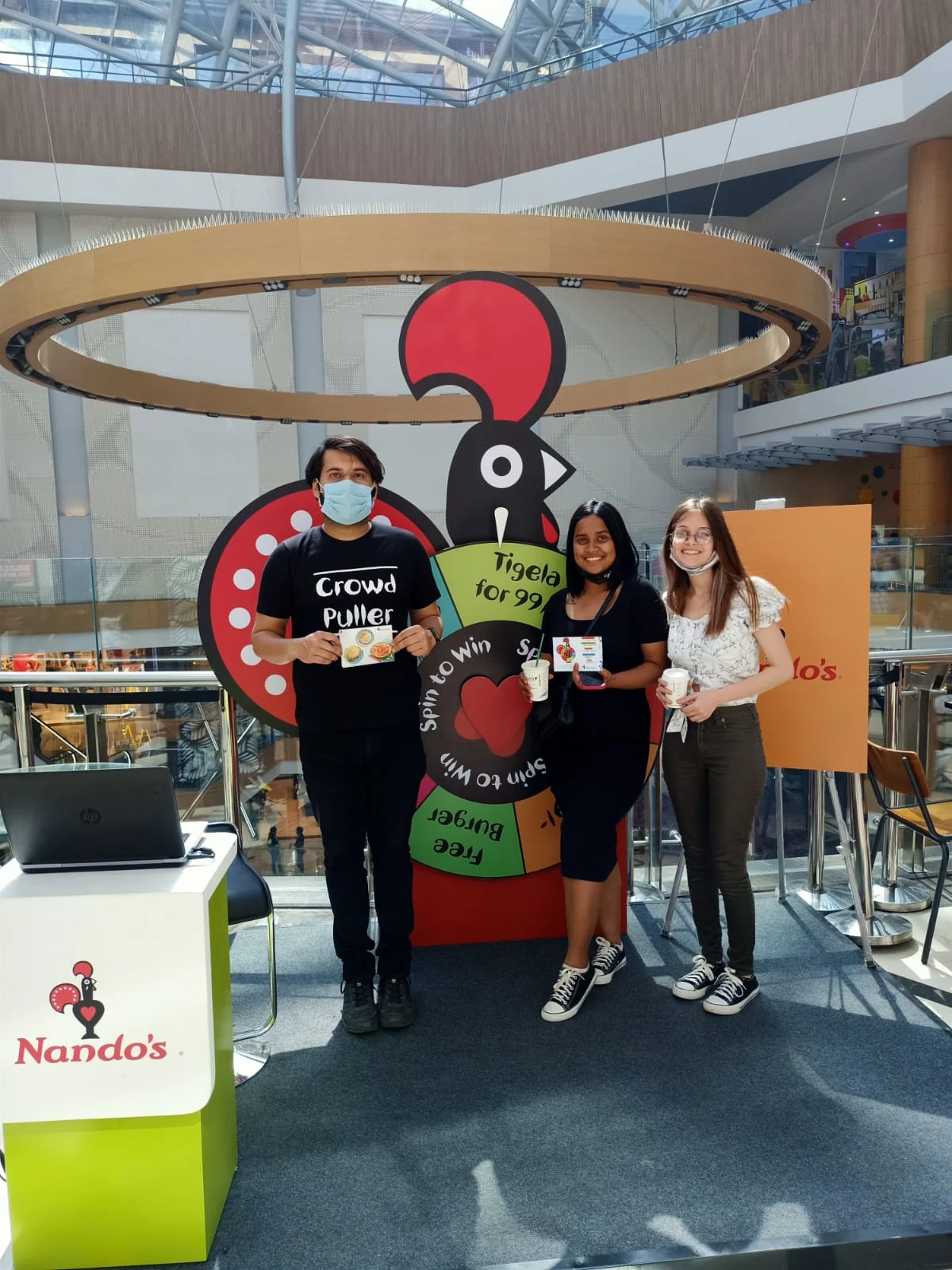 Guests posing with the team at the Nando's rooster wheel