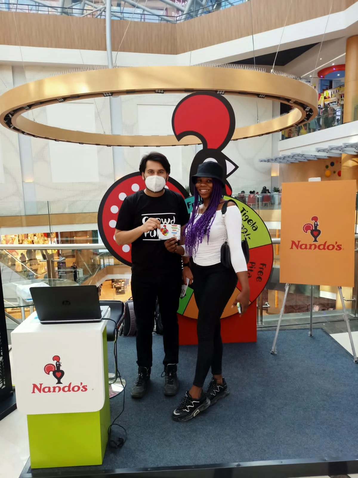 Couple collecting their instant reward at the Nando's activation kiosk