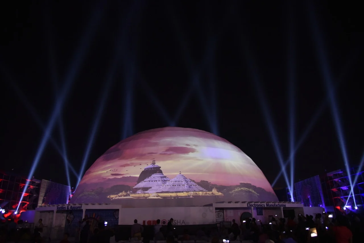 Geodesic dome projection mapping with temple artwork and light beams at night