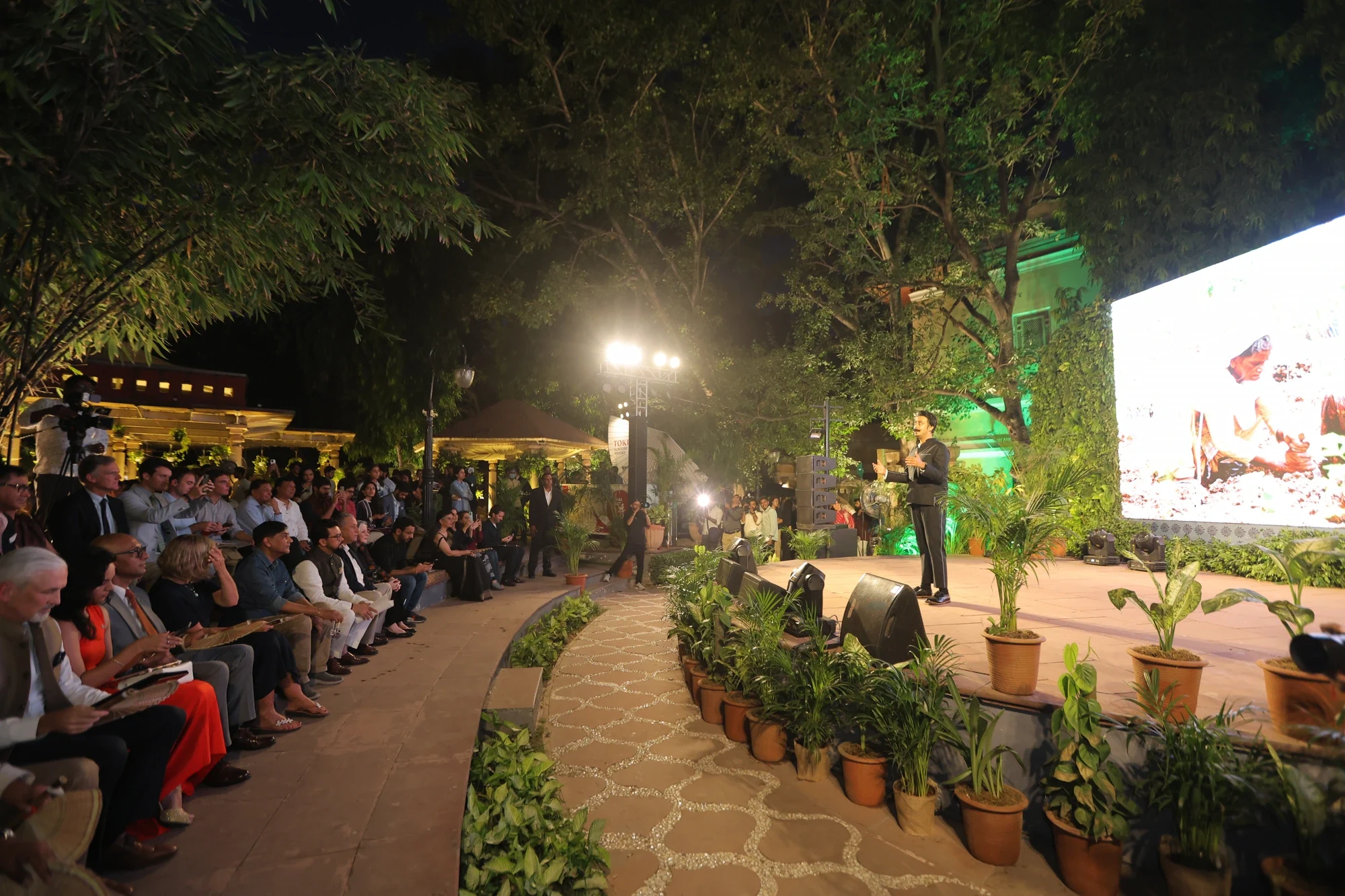 Keynote on the open-air stage under the trees with the Planet India preview on screen
