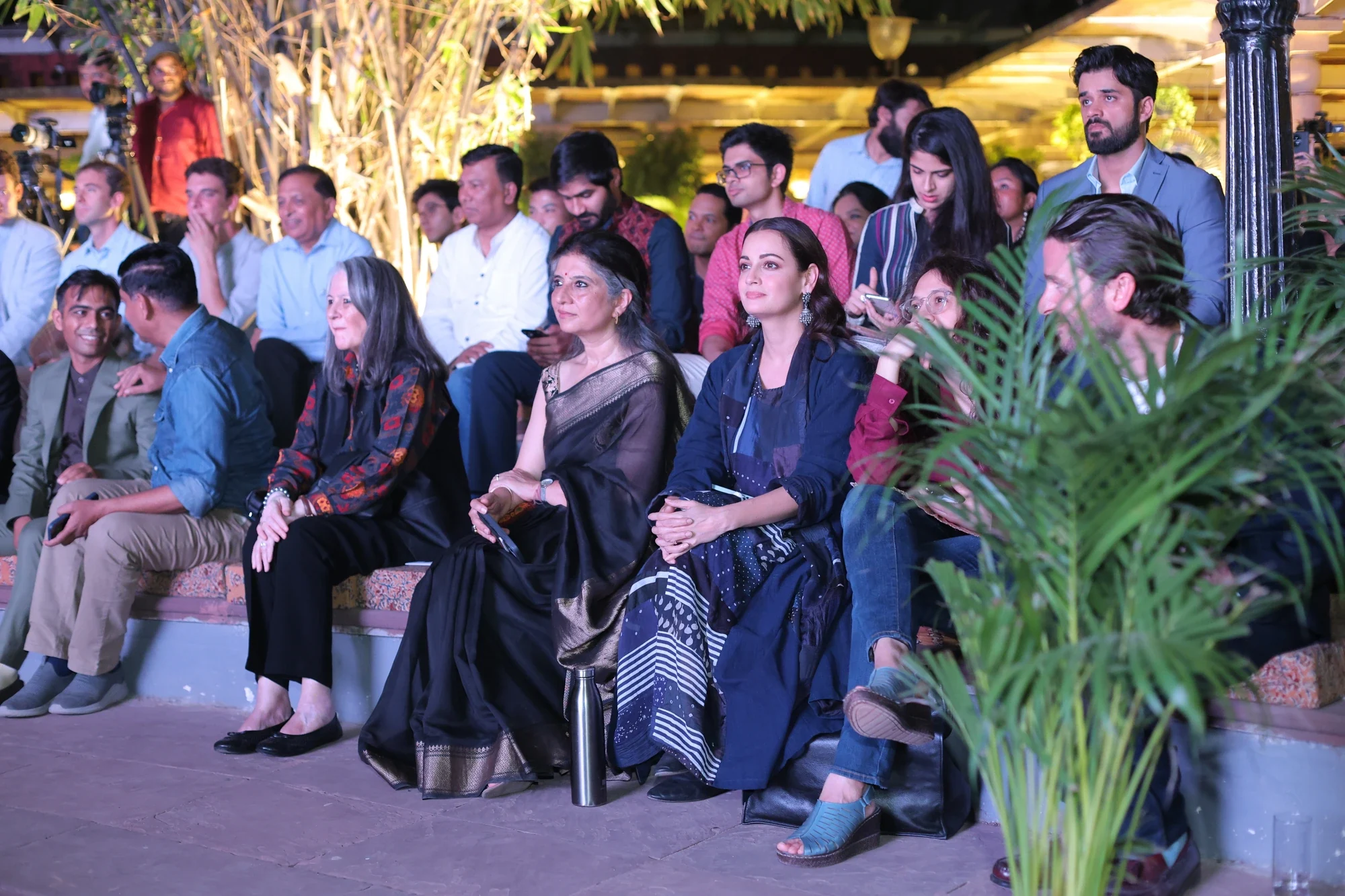 Guests watching the evening's talks from the amphitheatre seating