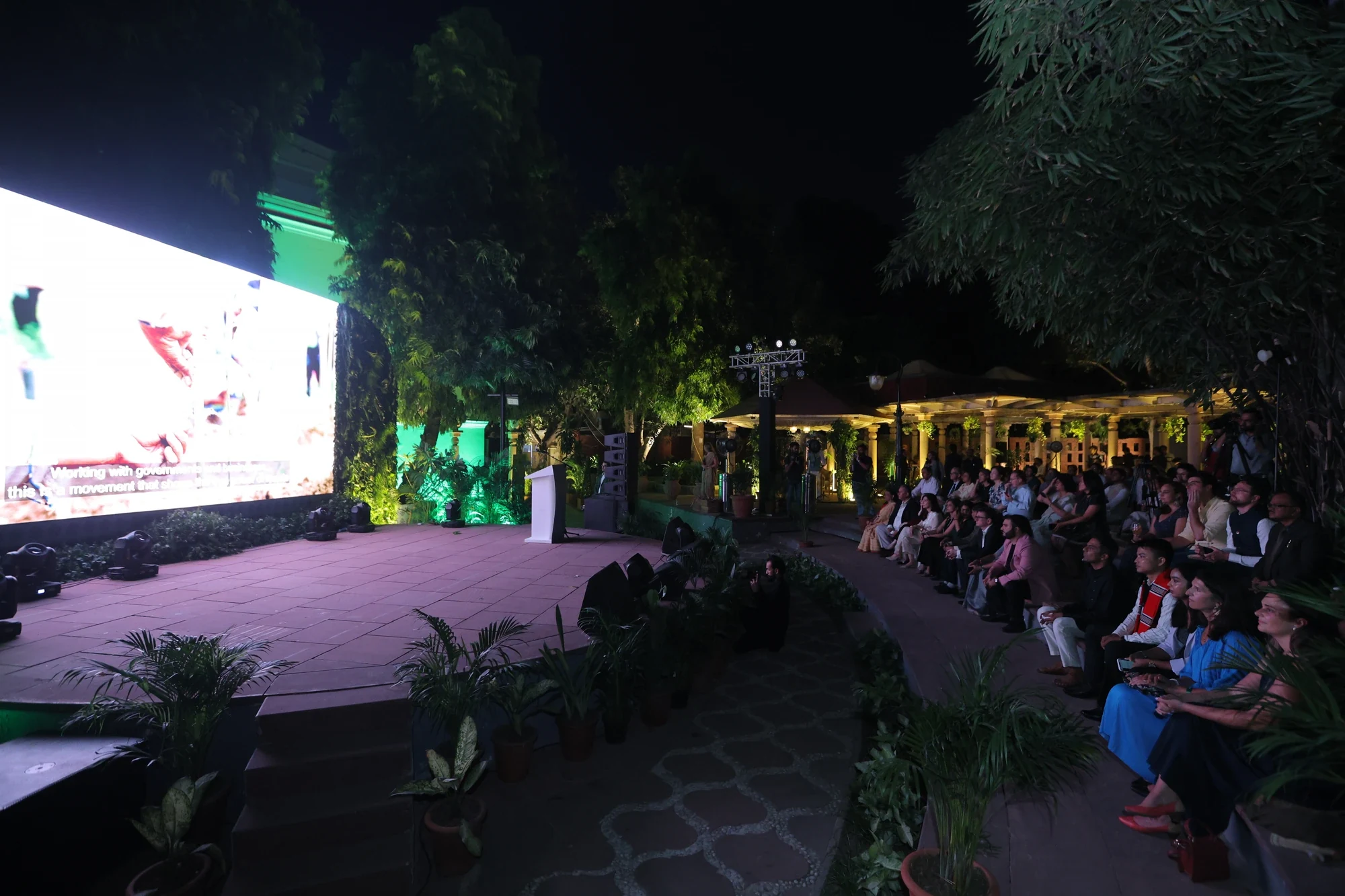 Wide night view of the open-air stage and amphitheatre audience