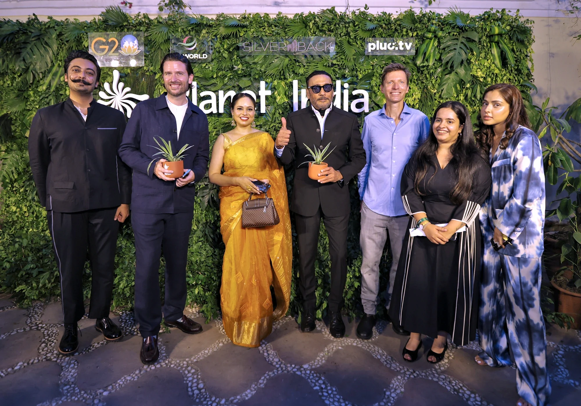 Guests with sapling gifts at the Planet India green wall