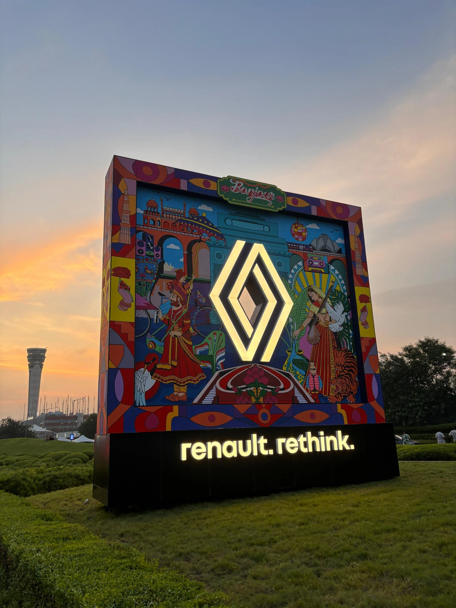 Renault installation glowing golden-yellow at dusk