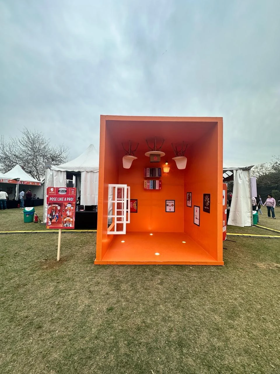 Pose Like a Pro — upside-down orange room photo installation
