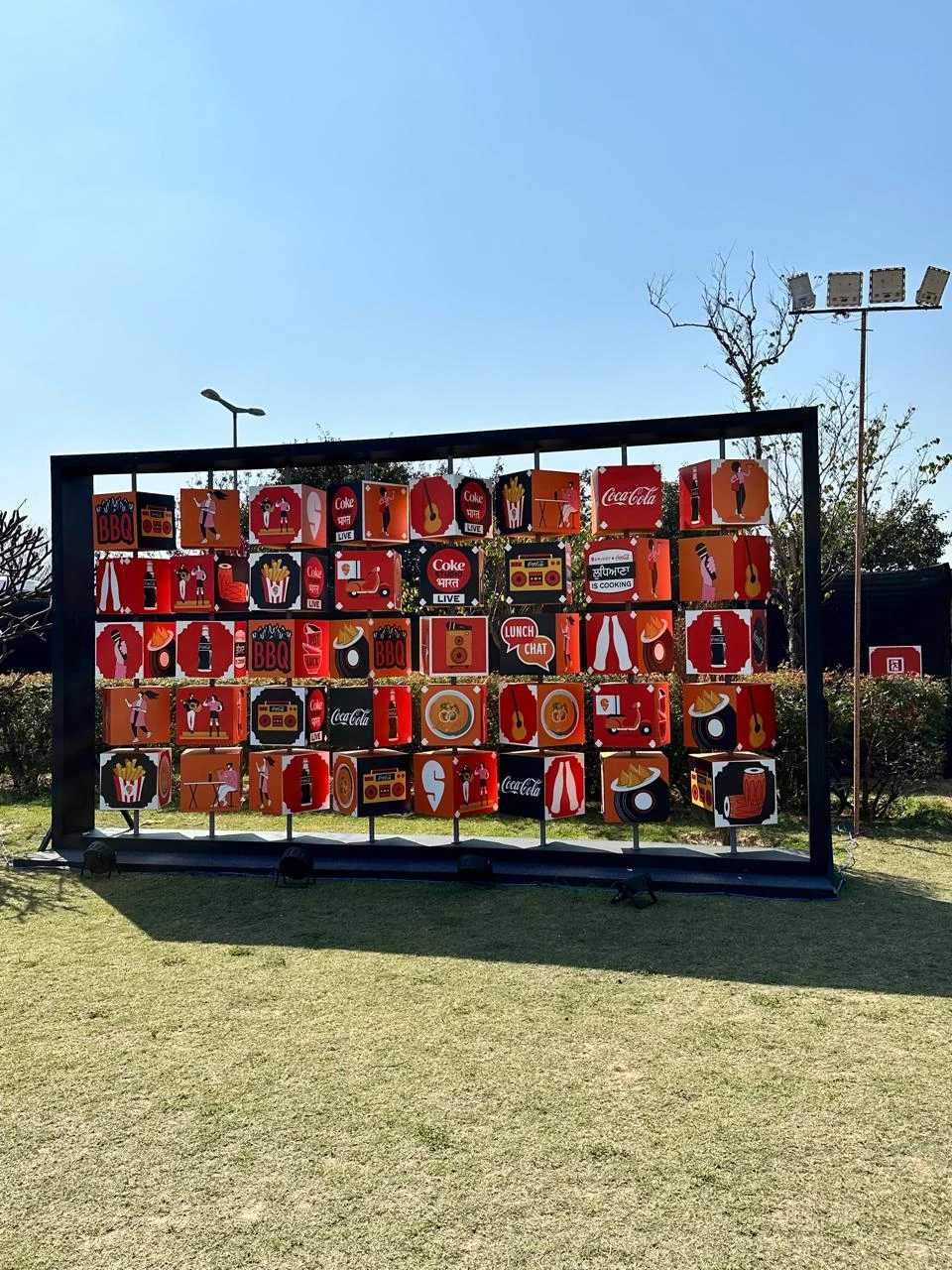 Rotating cube art wall of Coke and Swiggy food illustrations