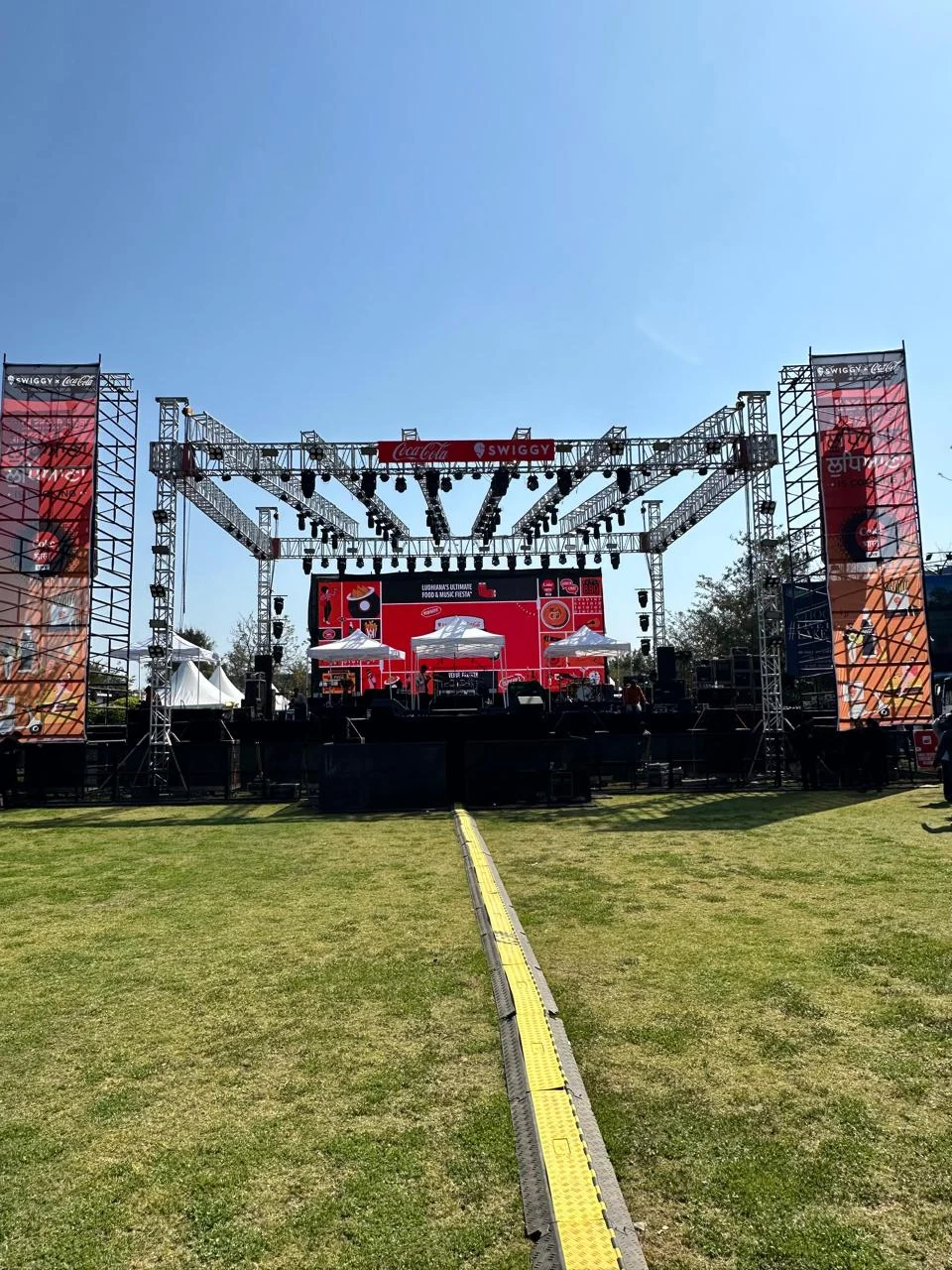 Coke Is Cooking main stage with full lighting rig and LED backdrop on the festival lawn