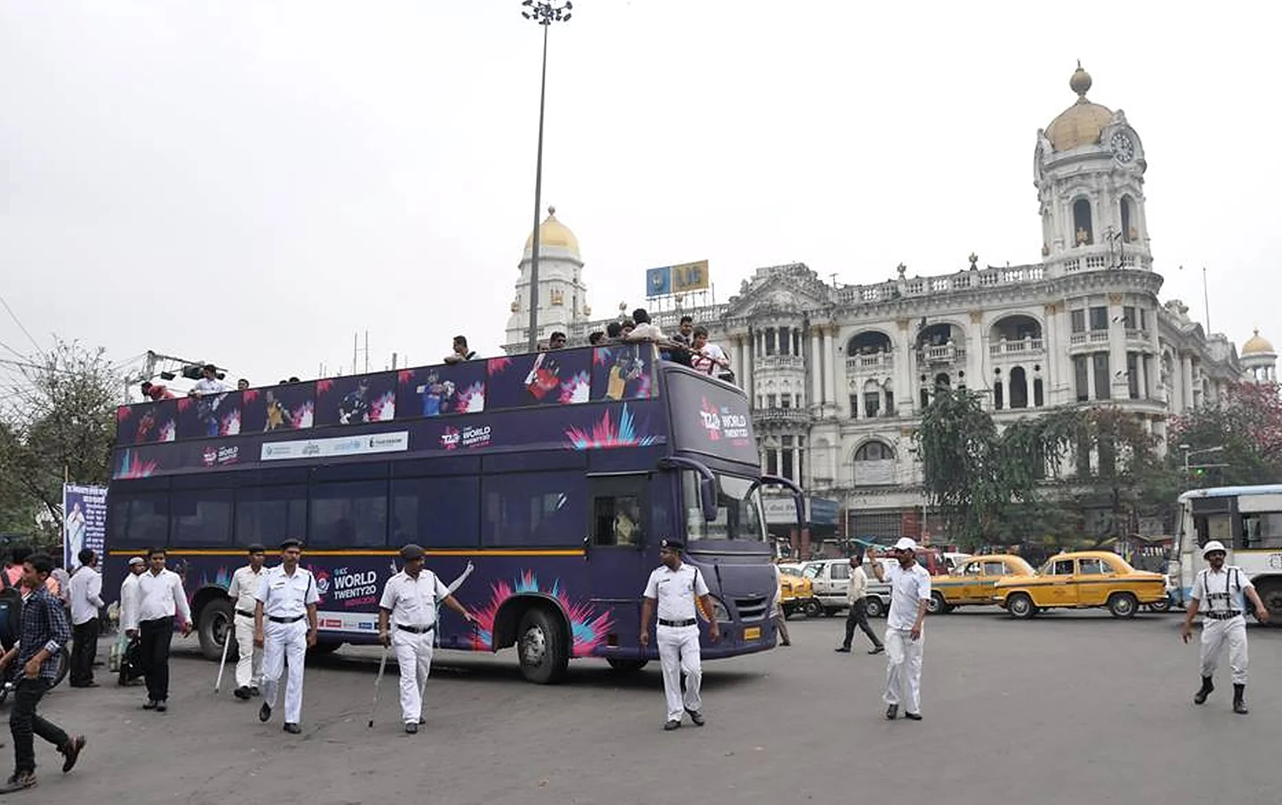 Branded ICC World Twenty20 double-decker bus touring Kolkata with police escort
