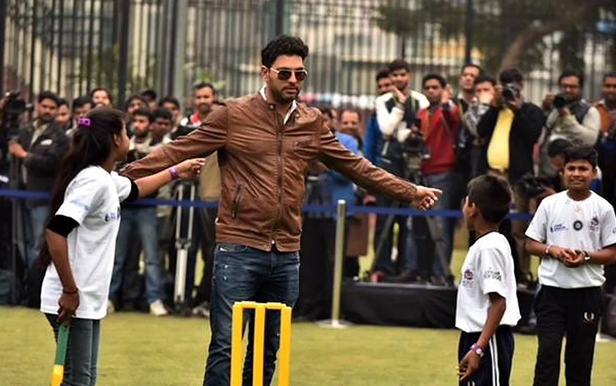 Cricketer playing a promotional cricket game with young fans during the tour