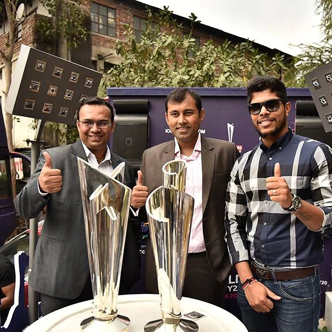 ICC World Twenty20 India 2016 trophy display with cricketer and officials giving a thumbs up
