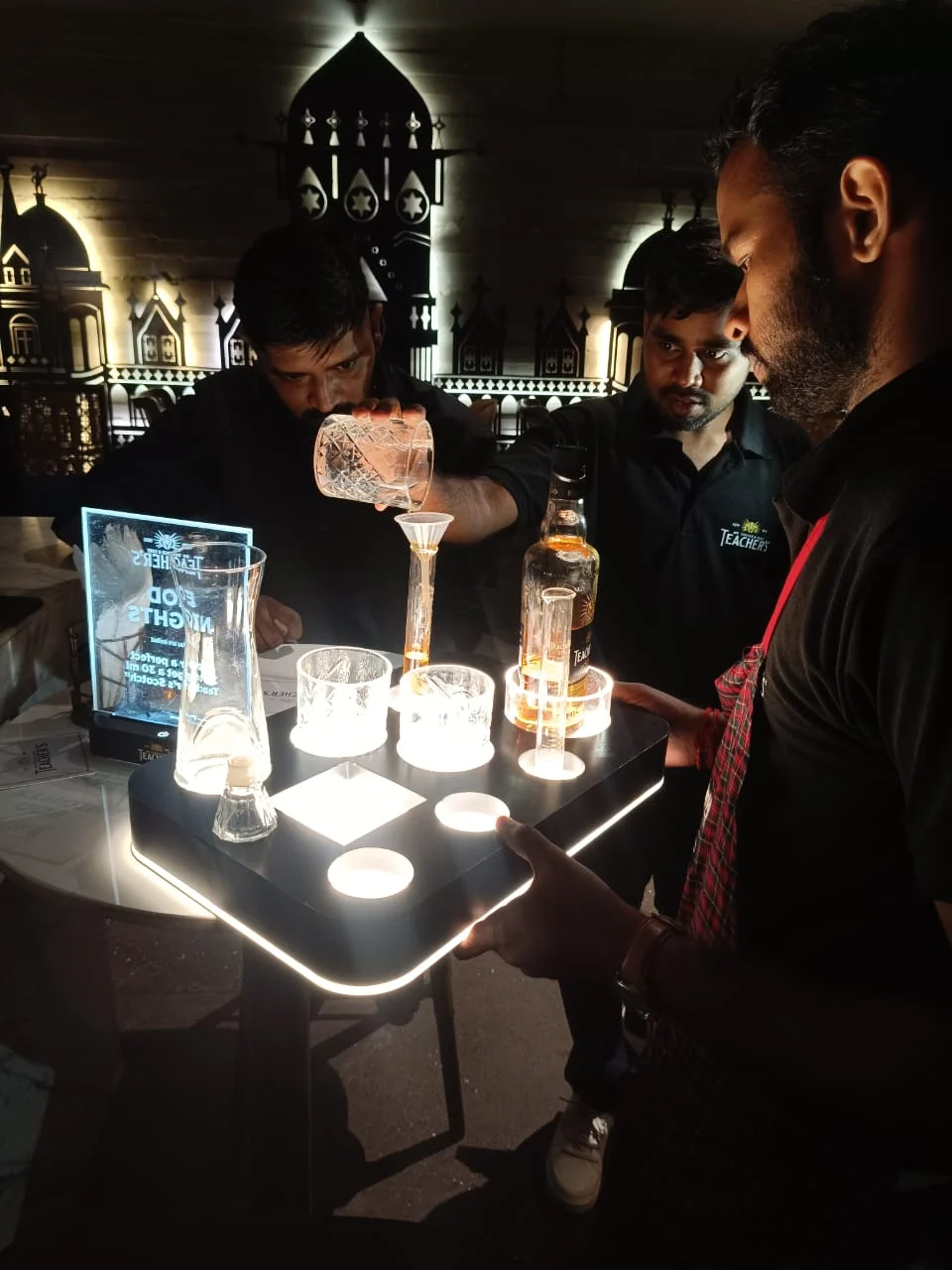 Teacher's Barry 30 activation — illuminated pour challenge at the bar
