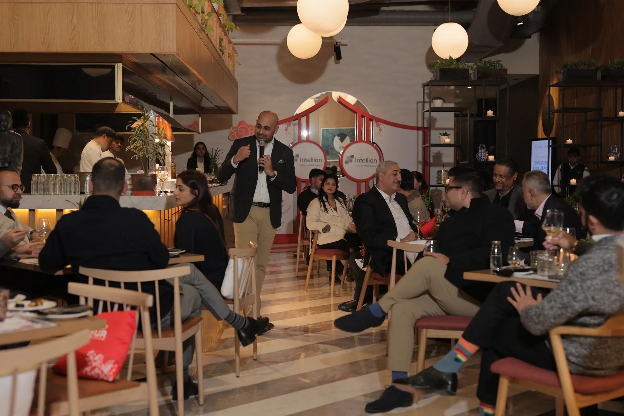 Speaker with microphone among guests at the Japanese-inspired Third Hour venue