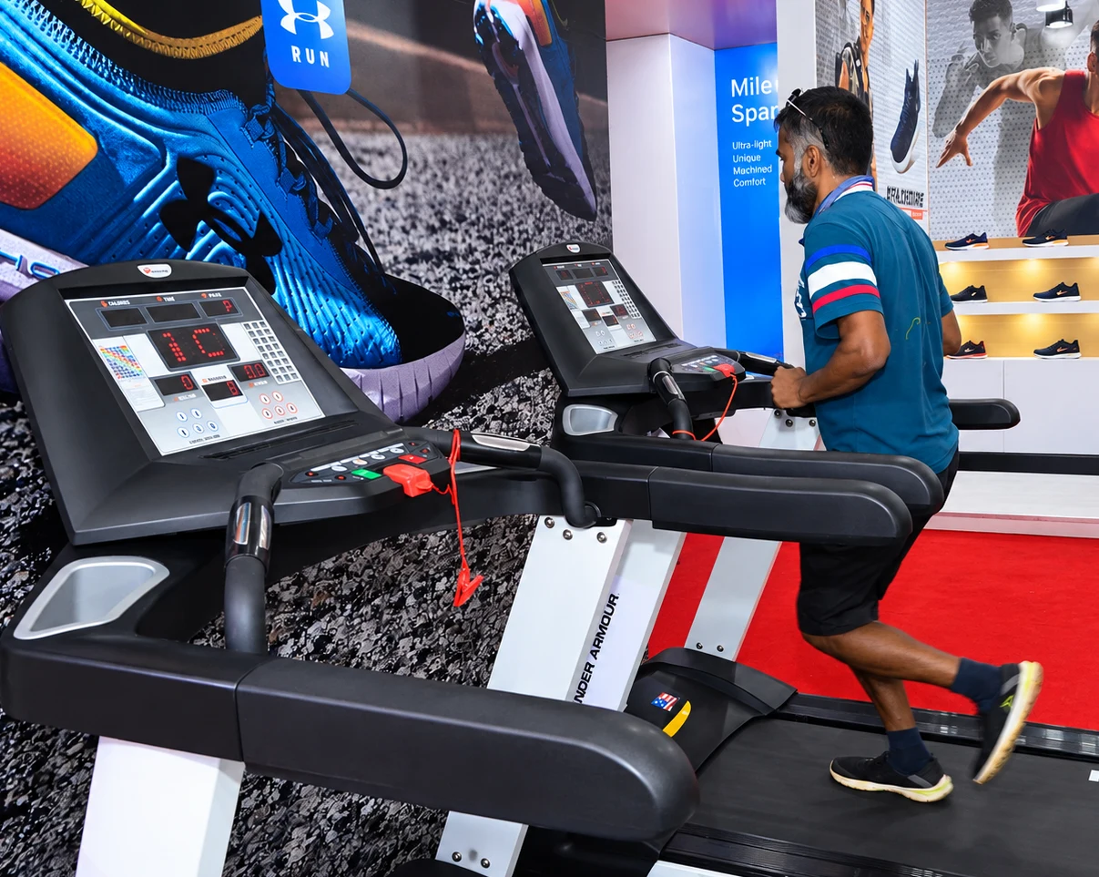 Visitor trying the Under Armour treadmill experience at the expo