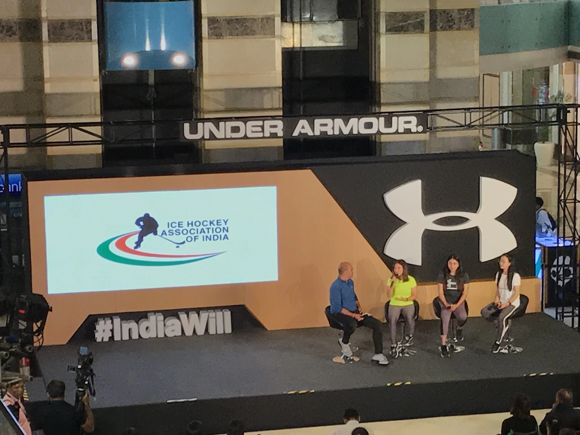 Ice Hockey Association of India announcement on the main screen at the Under Armour press conference